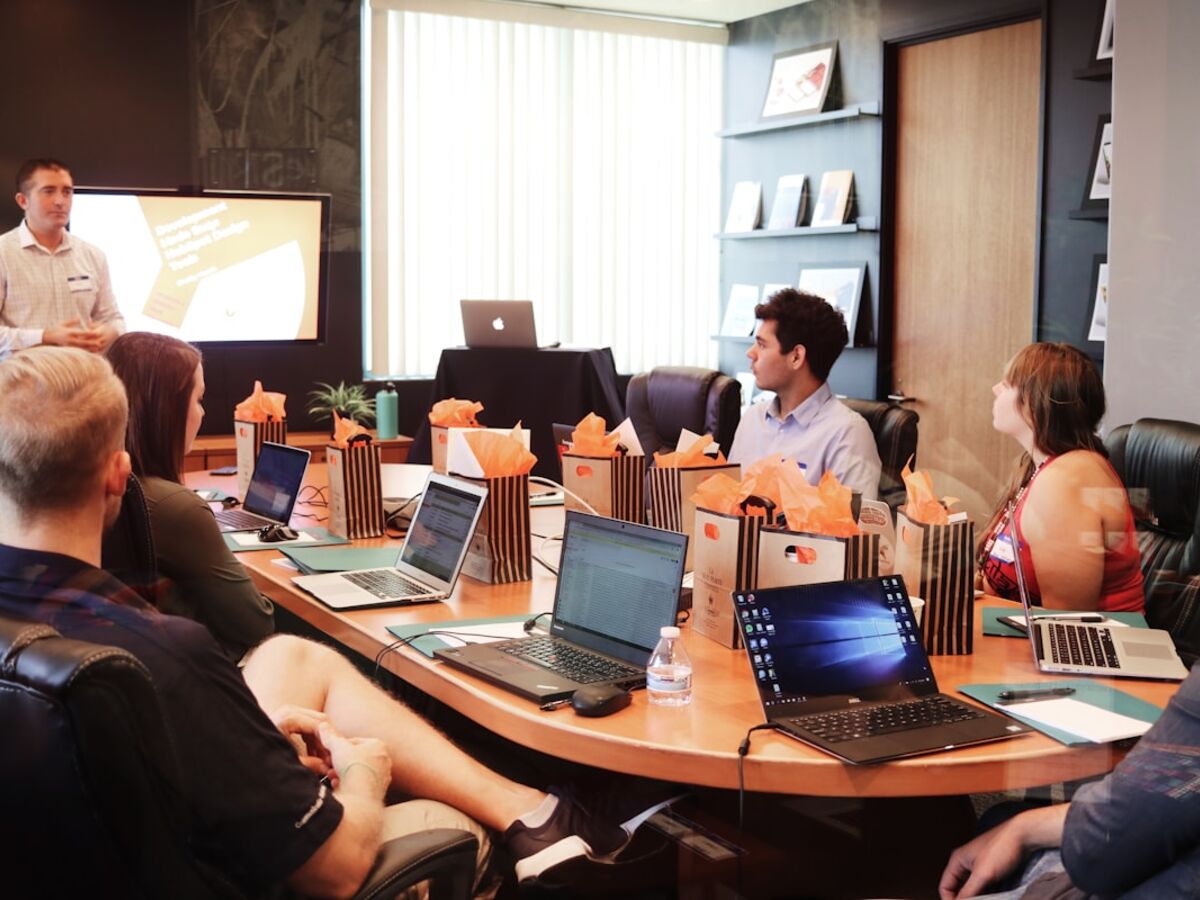 Team collaborating around a table — white-label agency to agency PR support